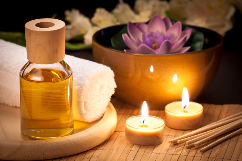 two burning candles with lotus decoration